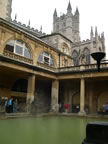 The top of the Bath Abbey appearing beyond the spa complex.