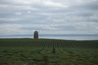 A lone windmill along the coast.