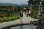 Melissa standing past the fountain toward the end of the walled garden.