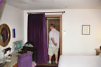 Chris heading from the bedroom toward to bathroom and room door. The curtain helpped keep the room nice and cool.
